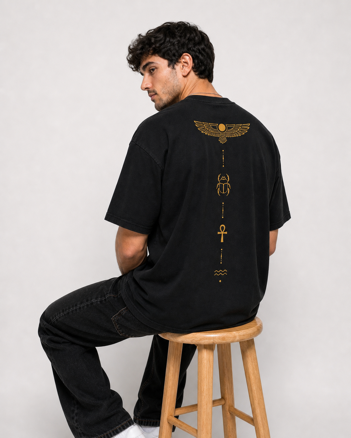 Color: Black | View: Back seated | Symbol Tee